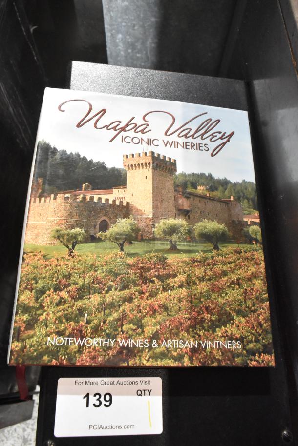 Book titled "Napa Valley: Iconic Wineries" showing a vineyard scene. Auction item number 139.