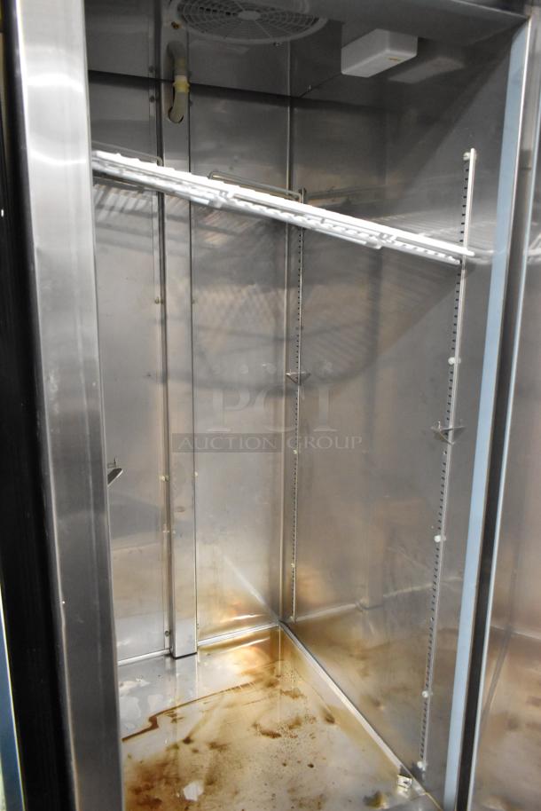 Ikon KB27F stainless steel commercial single door reach-in freezer, interior view, on commercial casters, 115V, 1 phase.