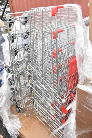 Four brand new chrome finish shopping carts with minor scratches and dents, red handles, and labels visible.