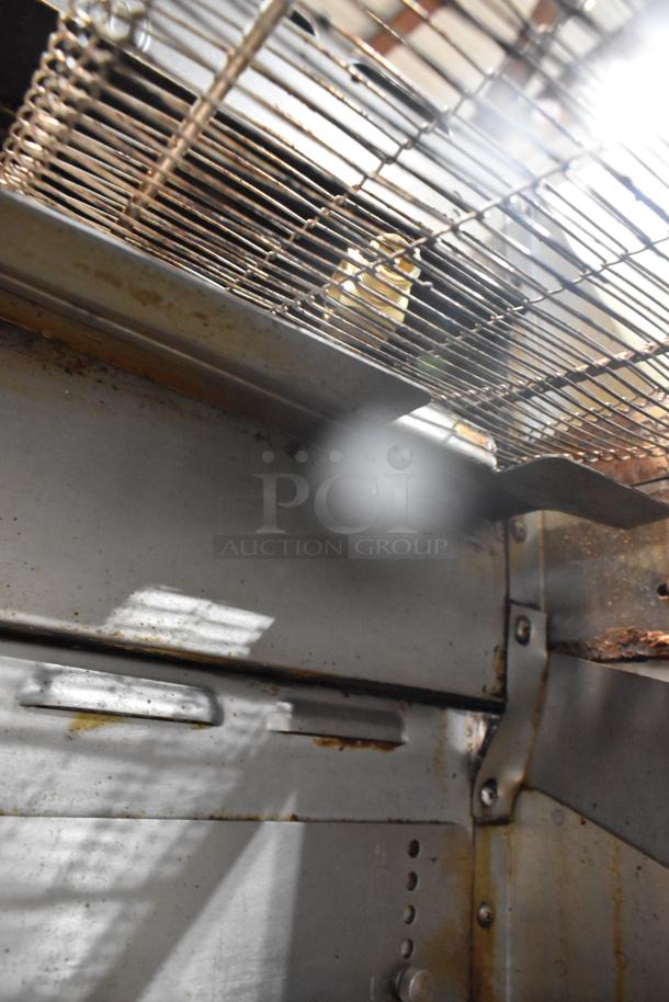 Interior view of 2017 Turbochef HhC2020 stainless steel commercial rapid cook conveyor oven, showing the metal wire conveyor belt and interior surfaces. Condition shows signs of use.