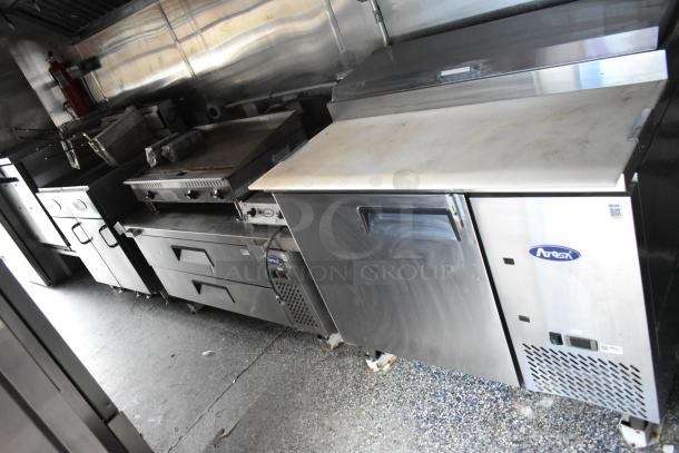 Mobile kitchen with Atosa pizza prep table, reach-in coolers, Royal gas fryers, Winco griddle; fully equipped and tested.