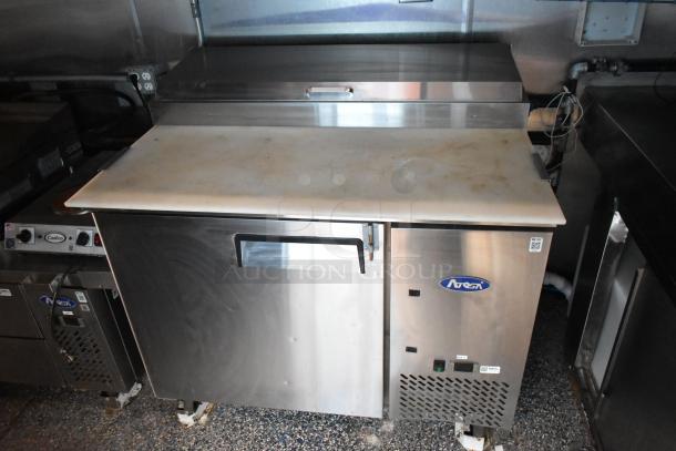 Atosa pizza prep table in stainless steel, commercial-grade, with cooling compartment, in mobile kitchen setting.