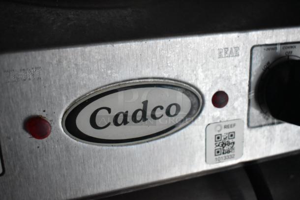 Cadco control panel with brand logo, red indicator light, and QR code for equipment model verification.