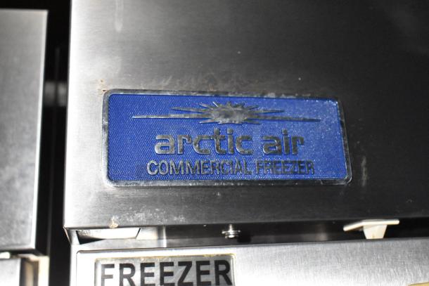Arctic Air Commercial Freezer label on stainless steel freezer, indicating durable commercial-grade equipment.