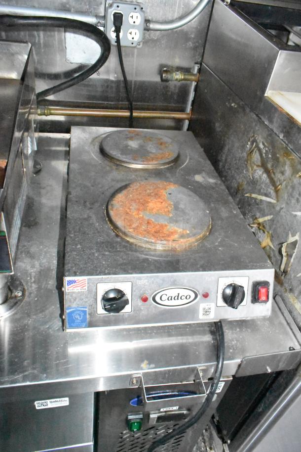 Cadco electric countertop hot plate with dual burners, showing signs of rust, part of mobile kitchen trailer equipment.