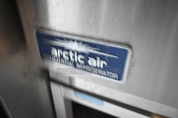 Blurred close-up of an Arctic Air commercial refrigerator label inside a fully outfitted 24' fast food trailer.