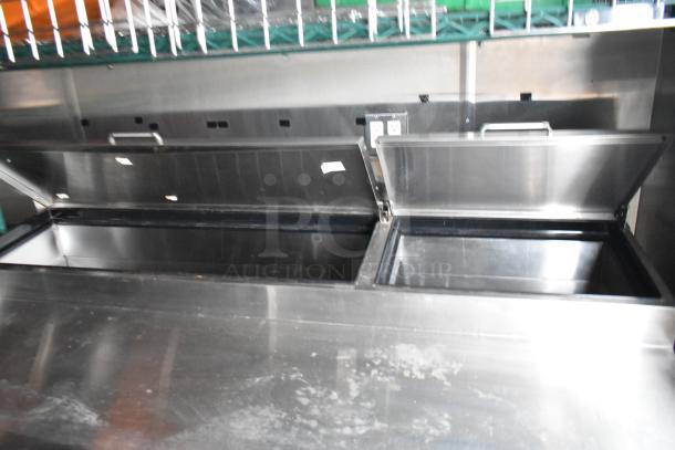 Commercial-grade stainless steel food prep table with dual lids open, part of a fully equipped 24' fast food trailer.