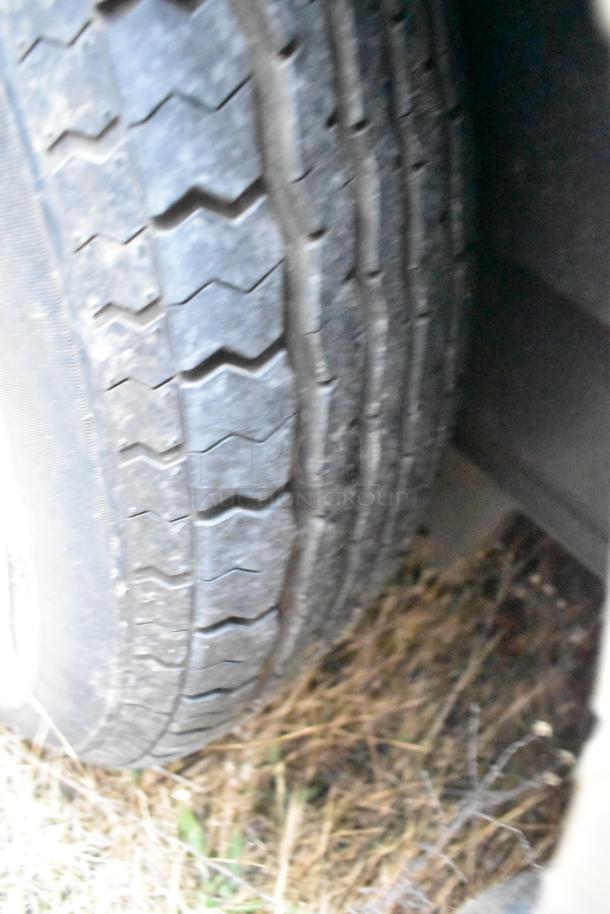 Close-up of tire tread on Stuff4less 24' food trailer, showing well-maintained condition.