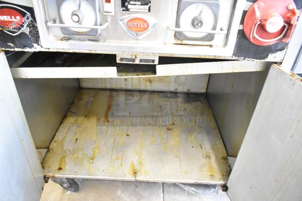 Wells VCS2000 Ventless Hood Cooking System with dual deep fat fryer, showing visible wear and grease stains.