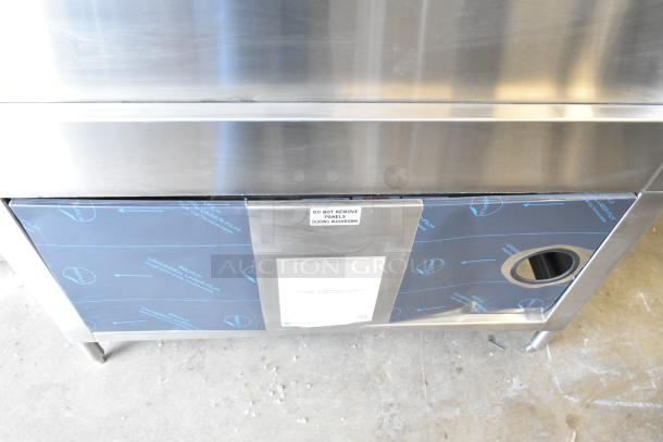 Douglas SD-20-ELEL commercial front load pot and pan washer. Stainless steel with protective film. Tag warns not to remove panels during washdown.