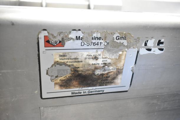 Treif Felix 100-CE industrial food dicer label, showing model, machine number, and voltage details. Signs of wear visible. Made in Germany.