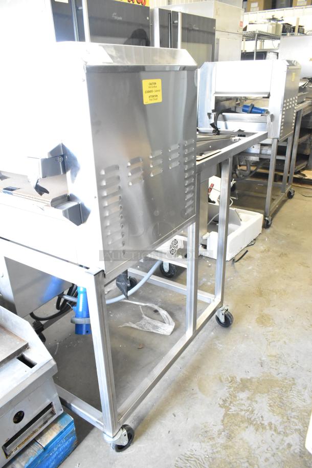 Belshaw Adamatic TG-50 stainless steel thermoglazing station, commercial casters, 208V 1-phase, good condition, caution label.