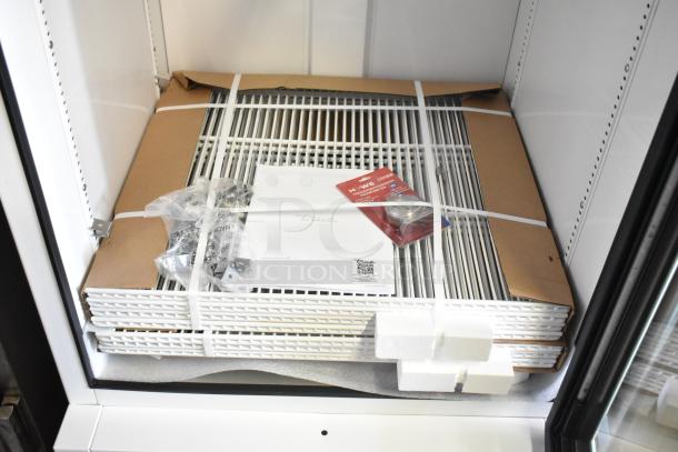 Brand new True TSCI-600R-G-PH single door cooler, features poly coated racks, metal finish, 115V, 1 phase, with manuals and accessories.