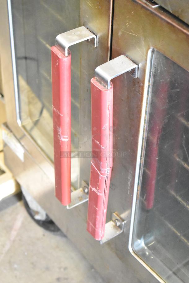 Vulcan VC4GD-10 convection oven with red handles and glass doors. Used condition with visible wear. Thermostatic controls.