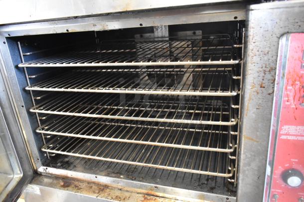 Vulcan VC4GD-10 convection oven with view-through doors, multiple racks, and thermostatic controls, visible wear.