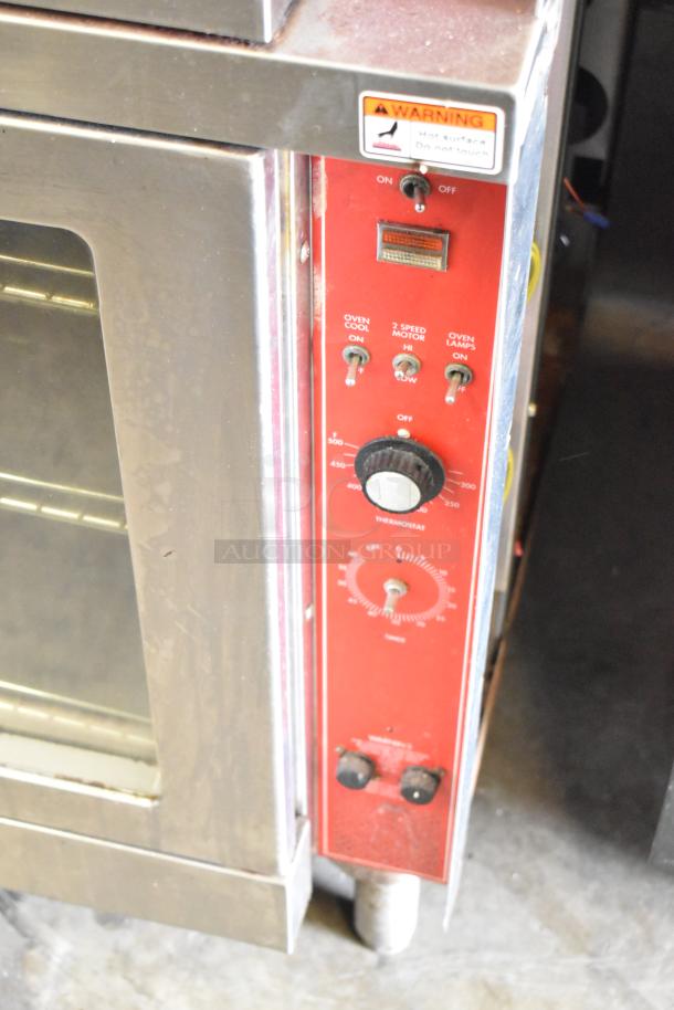 Vulcan commercial convection oven with view-through doors and thermostatic controls; warning label visible, slightly worn condition.