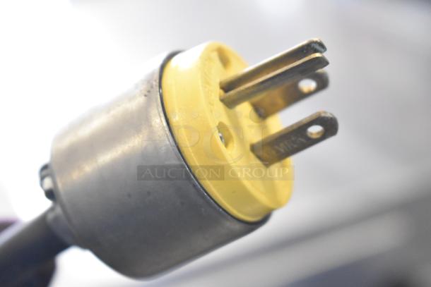 Close-up of a yellow three-pronged electrical plug with metal casing, part of 2021 Manitowoc IYT0420A-161X Ice Machine.