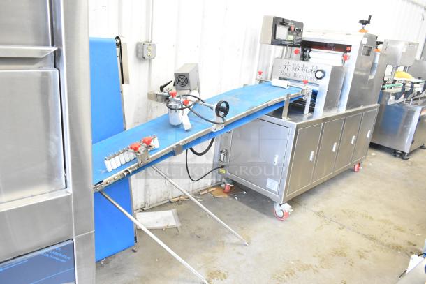 Seny Machinery SY-860 automatic bread maker, stainless steel, 220 volts, features labeling and conveyor belt, excellent condition.