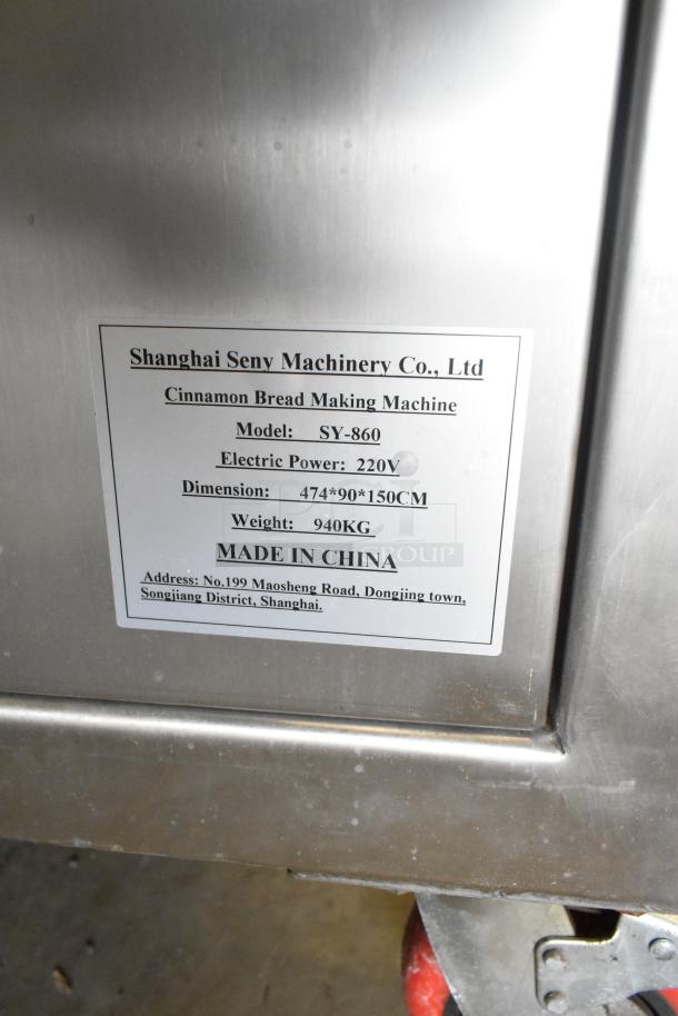 Seny Machinery SY-860 automatic bread machine, 220V, dimensions 474x90x150cm, 940kg, label showing specs and origin.