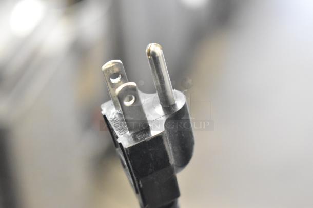 Close-up of a black electrical plug for a Halo Bug Zapper, 115 volts, 1 phase, with visible three-prong design.