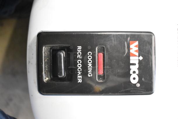 Winco RC-P300 Rice Cooker control panel with power switch and cooking indicator. Brand logo visible. Used condition.