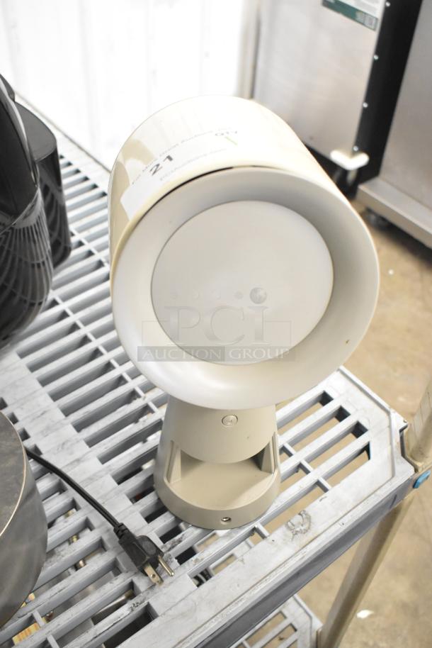 Portable countertop range hood, beige, cylindrical design, features power cord and control button, in good condition.