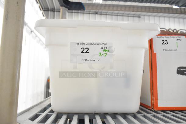 Container holding various cookie machine parts, marked "Lot 22, Quantity 7, PCI Auctions." Suitable for equipment buyers.