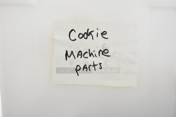 Label stating "Cookie Machine Parts" on a white background. Part of a lot with 7 various items.