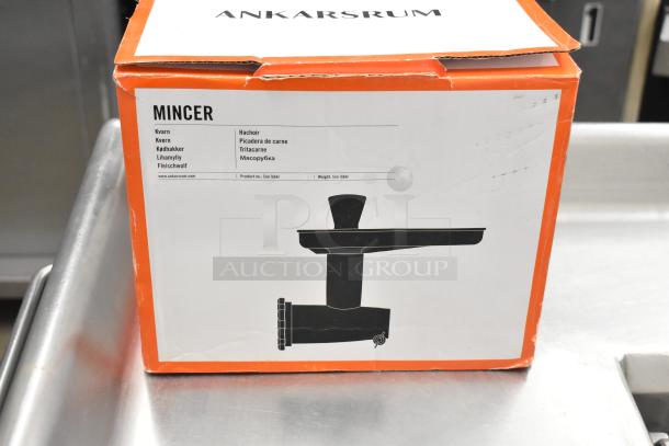 IN ORIGINAL BOX! Ankarsrum Meat Grinder Attachment, new condition, labeled "Mincer" with multilingual details, model image shown.