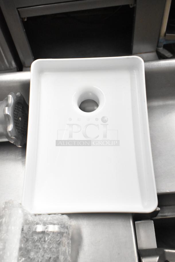 Ankarsrum meat grinder attachment, shown with a white tray. Includes original parts, appears new, packaged with protective wrap.