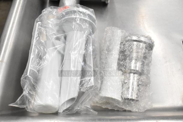 Ankarsrum meat grinder attachment, new condition, in original packaging with plastic wrap and bubble wrap for protection.