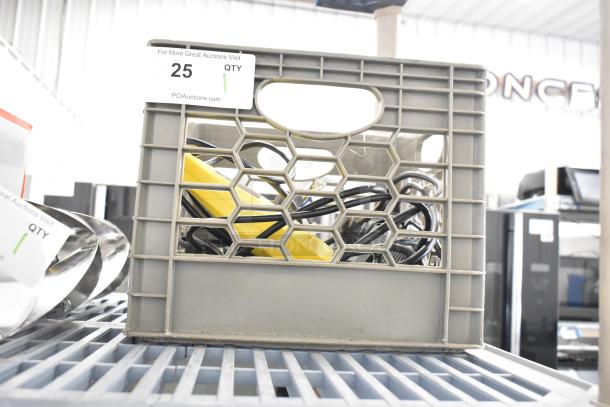 Stanley Electric Stapler/Nail Gun stored in a gray crate, visible power cords, auction tag with "25" and "PCIauctions.com" displayed.