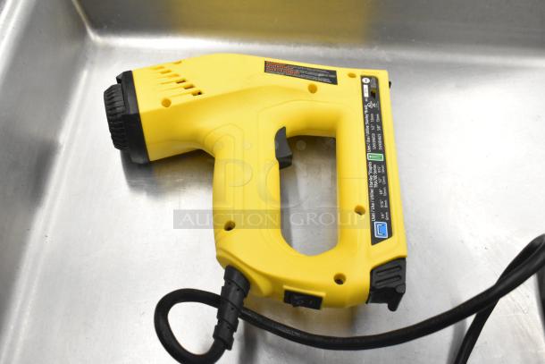 Stanley Electric Stapler/Nail Gun, yellow, in good condition with visible label indicating compatible staples and nails.
