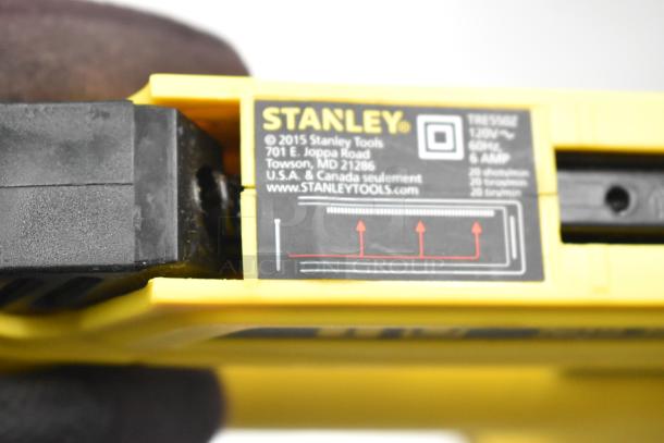 Stanley electric stapler/nail gun, model TRE550Z, 120V, 60Hz, 6 AMP, yellow, shown in used condition with label details.