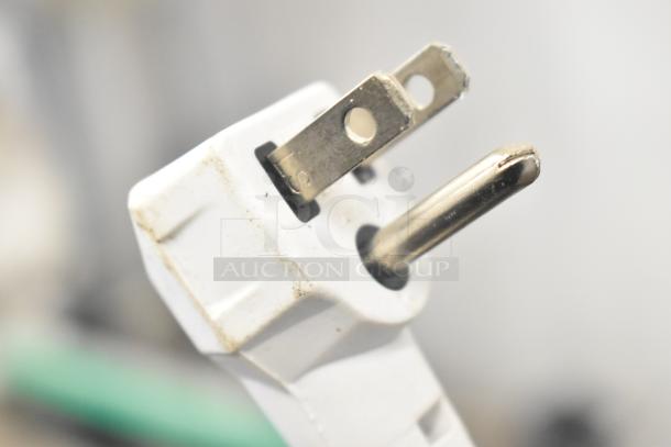 Close-up of Gardner WS-95 Bug Zapper plug, 120 volts, 1 phase. Features metallic prongs with visible wear.