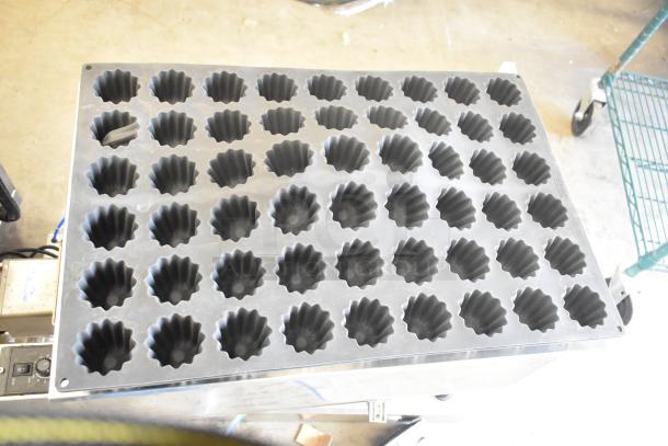 Mold baking pan liner with multiple cavities, dark finish, slightly worn. Ideal for baking, part of a 7-item auction lot.