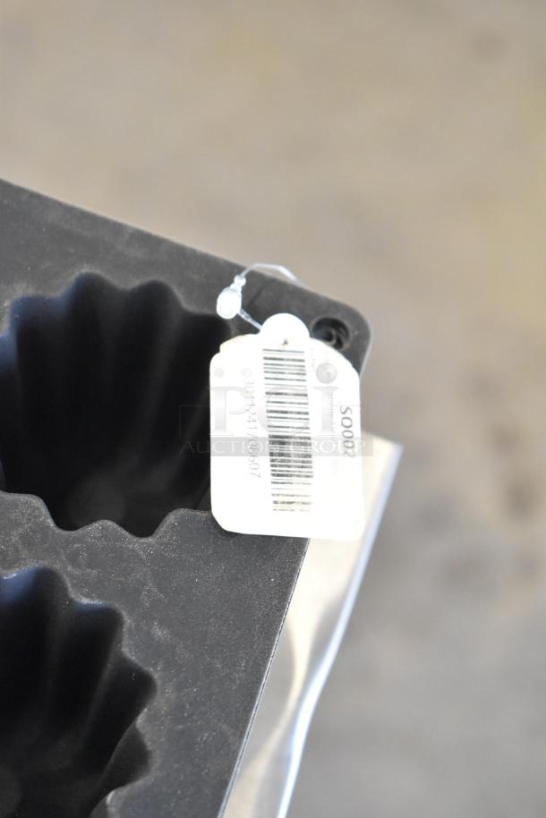 Black mold baking pan liner with fluted edges, visible barcode tag numbered 3011241708607.