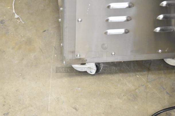 Luohe Orange floor style filling machine on commercial casters, 220V, 3 phase, in good condition, stainless steel casing.