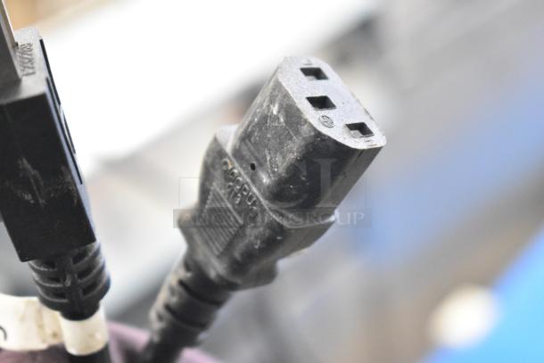 Close-up of a black power plug for the 2023 ZD200E-1 Countertop Pastry Donut Filling Machine. Model ZD200E-1, 110V, 1 Phase.