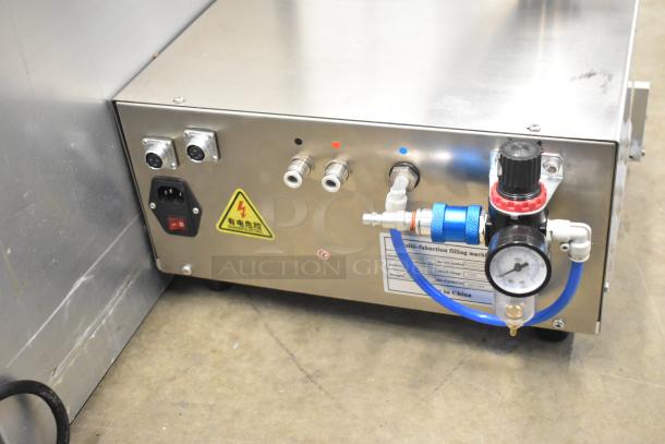 2023 ZD200E-1 countertop pastry donut filling machine, 110 volts, 1 phase. Features dial and valve controls, excellent condition.