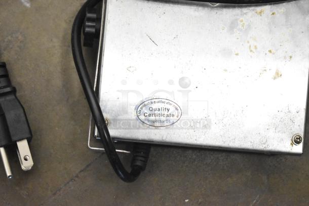 Metal device with plug, some wear. Visible label reads "Quality Certificate, Inspector: 01." Part of various item lot.