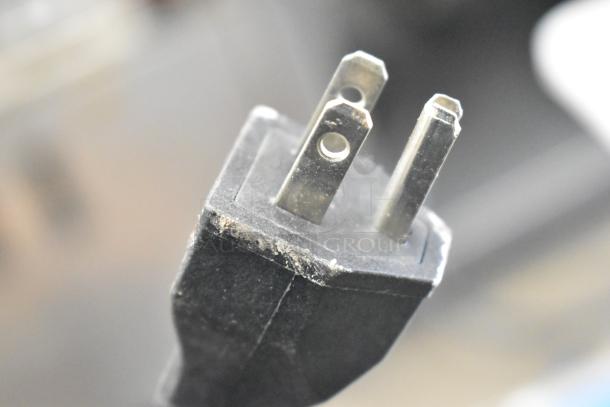 Close-up of a plug from the 2023 C12 Countertop Semi Automatic Round Bottle Labeling Machine. 220 Volts, 1 Phase.