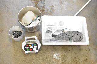 Lot of various items including timer, cookware, citrus juicer part, and white bin. Mixed materials, good condition.