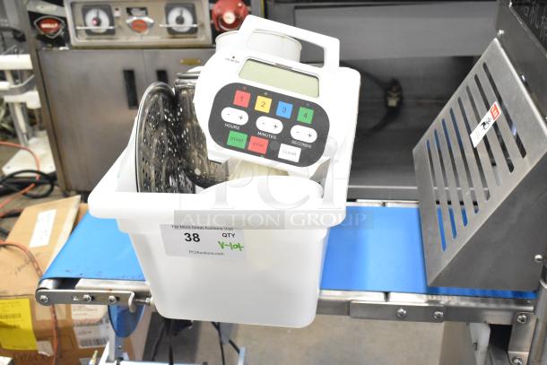 Lot of various items including digital timer, pan, citrus juicer part in a plastic bin. Auction tag labeled "38 QTY".