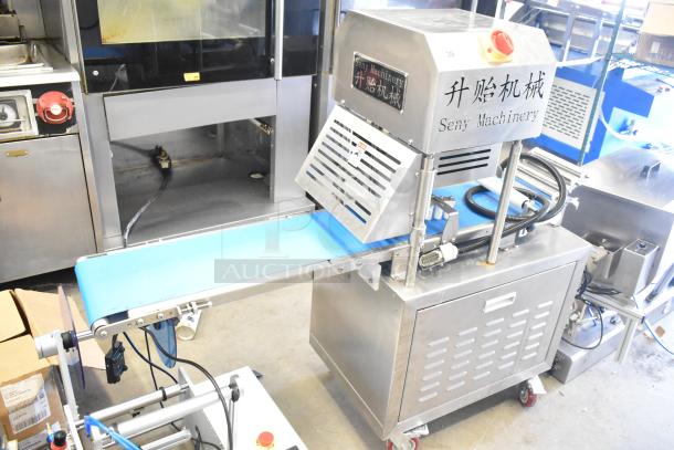 Seny Machinery commercial slicer and conveyor machine on casters, 220 volts, stainless steel, excellent condition.