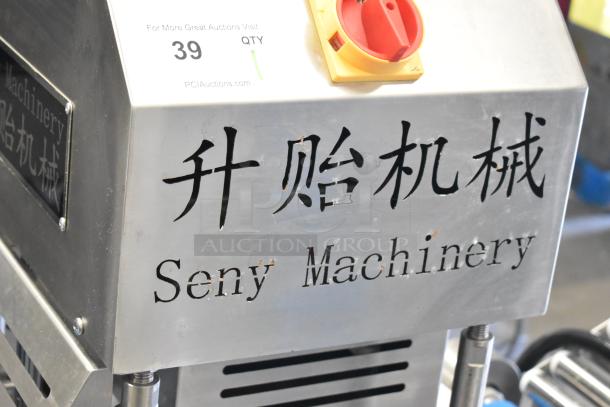 Seny Machinery slicer on casters, 220V. Features metal casing with brand name and rotary control. Good condition.