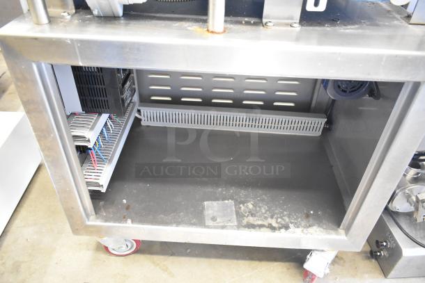 Seny Machinery floor slicer with conveyor on commercial casters, 220V, stainless steel, visible wiring and components, used.