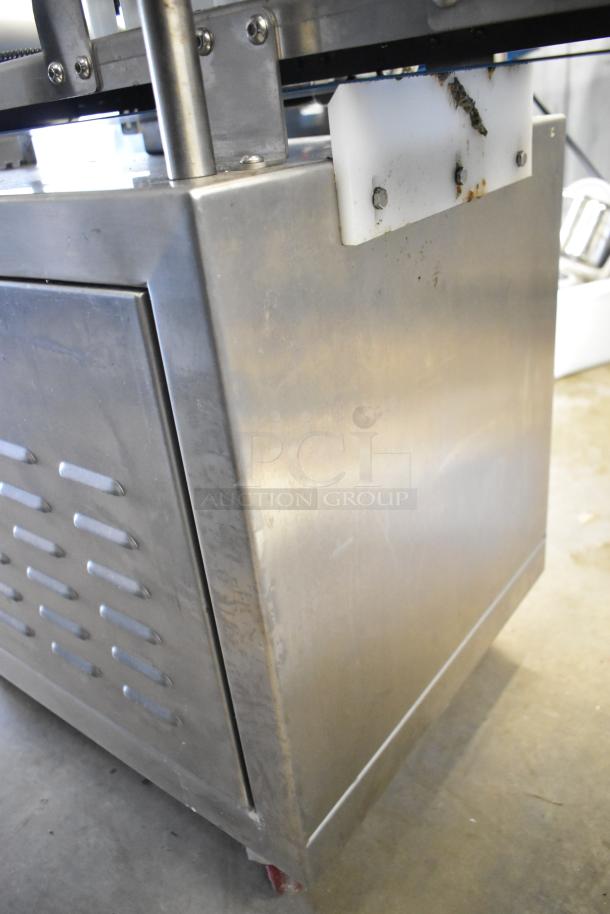 Seny Machinery commercial slicer and conveyor on casters. Stainless steel, 220 volts. Shows some wear.