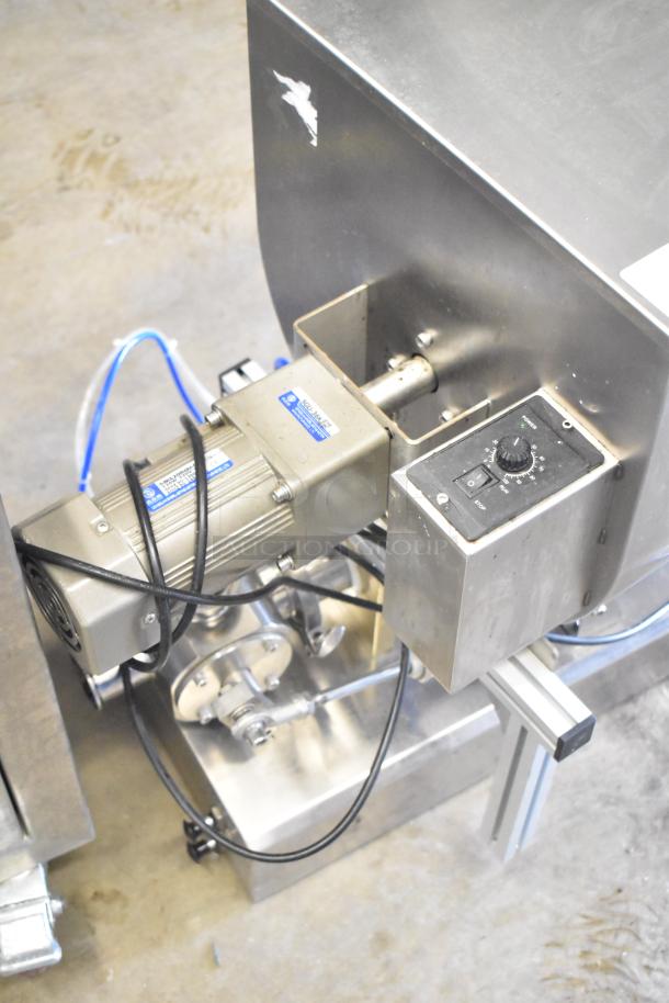 Commercial countertop meat mixer with foot pedal, stainless steel body, control panel, and visible wiring. Good condition.