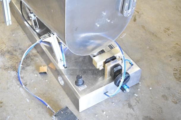 Commercial countertop meat mixer with foot pedal, stainless steel, used condition, visible wiring and attachments.